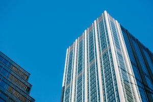 From below of contemporary multistory tall house under cloudless bright blue sky in daytime