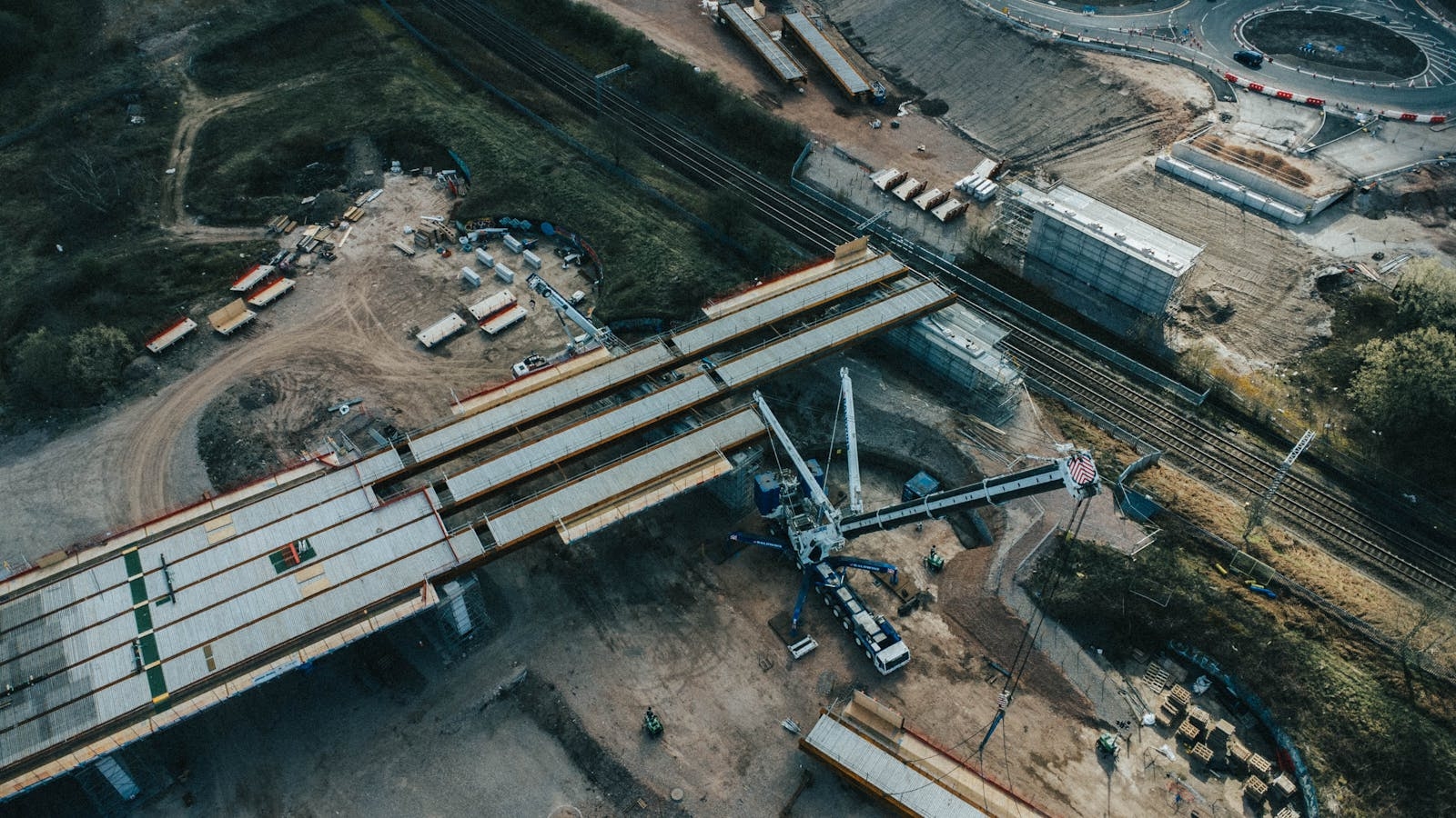A birds-eye view of a highway construction site with machinery and structures.