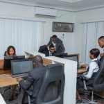 A group of professionals working together in a modern office setting, emphasizing teamwork and productivity.