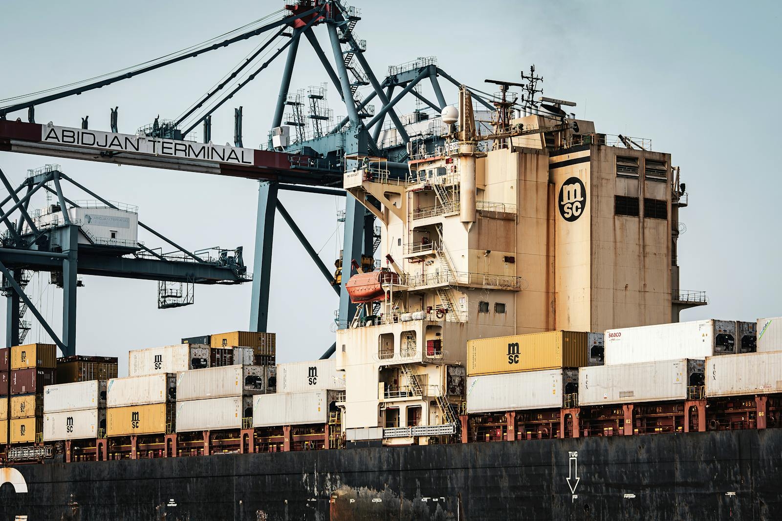 View of shipping containers and cranes at Abidjan Terminal, Ivory Coast.