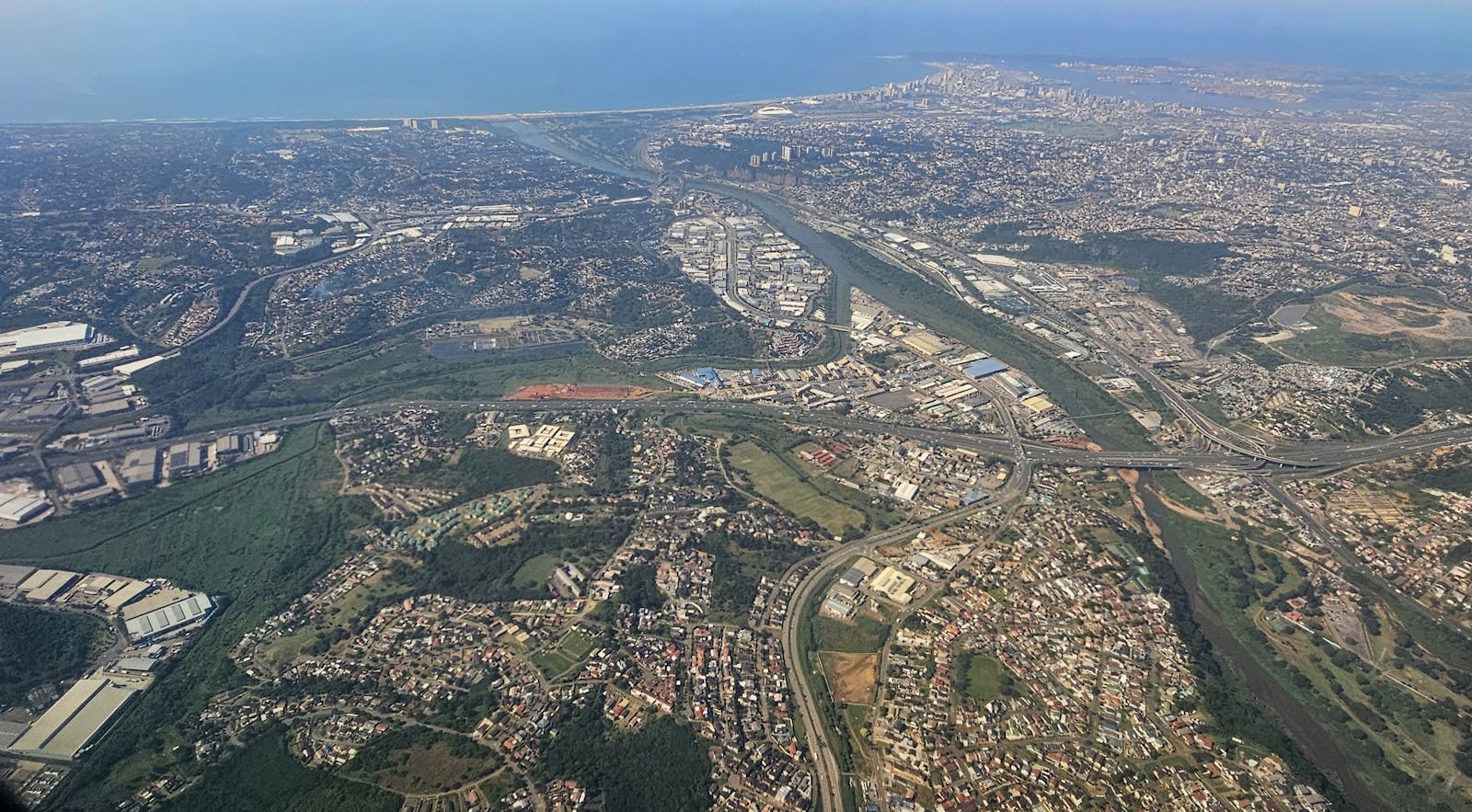 A scenic aerial view capturing the urban and natural landscape of a coastal city.