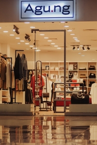 Inviting fashion retail store with open entrance and stylish interior under warm lighting.