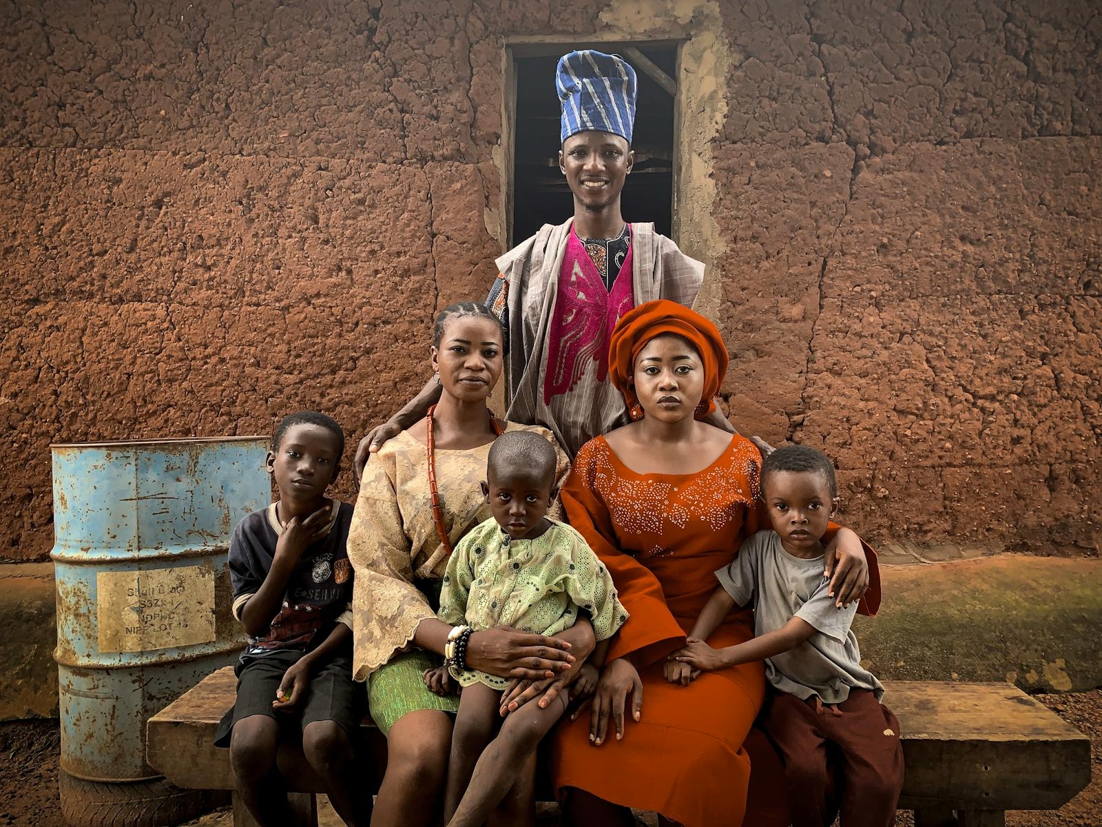 A joyful family in traditional Nigerian clothing, showcasing cultural heritage in Abeokuta, Nigeria.
