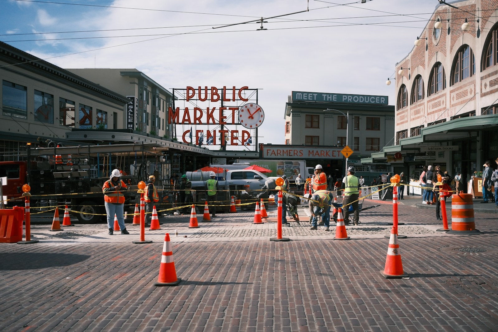 Workers in hard hats at a public market center
