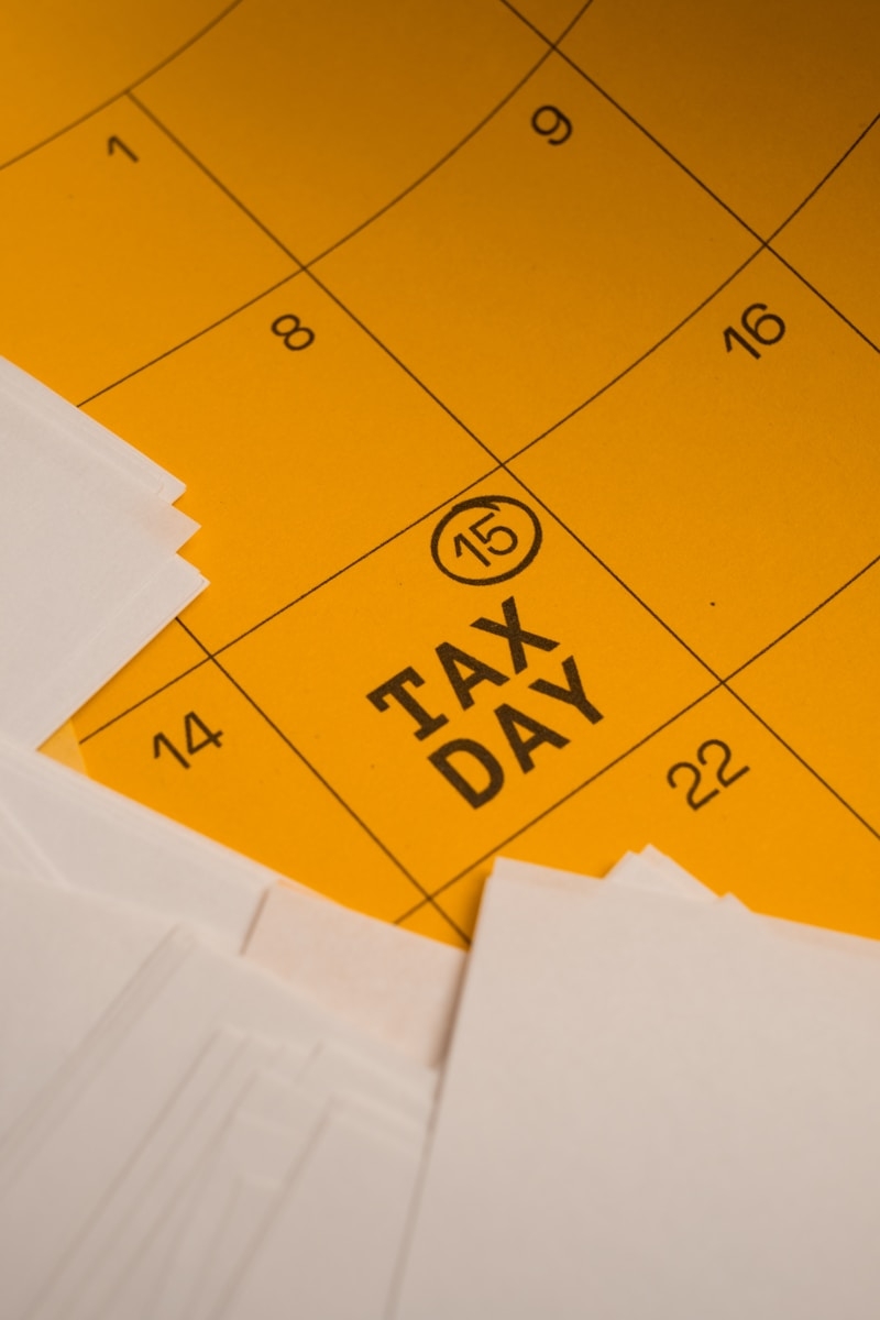 Calendar marked with tax day and circled date 15th circled