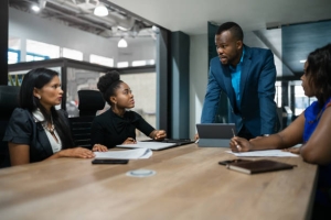 Nigerian business leader discussing risk culture with team members in a Lagos corporate boardroom