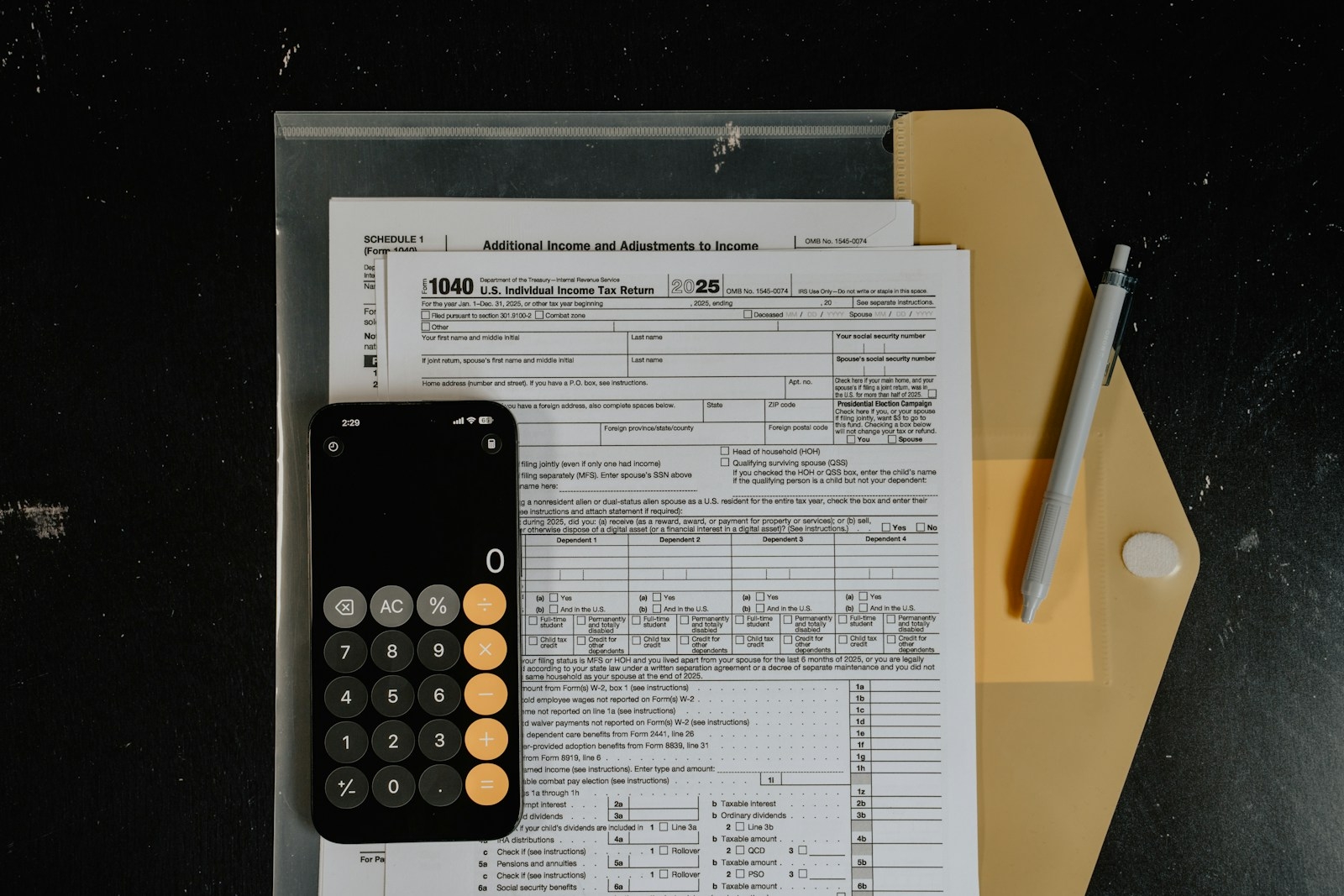 Calculator and pen on tax forms