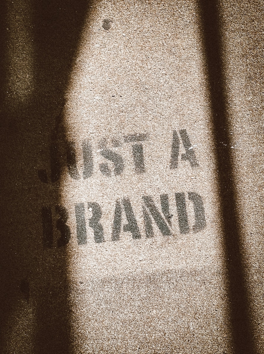 the shadow of a person standing in front of a sign